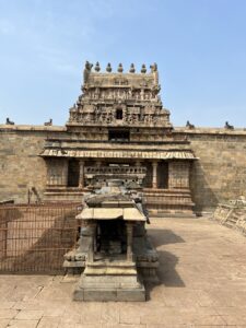 The front courtyard is in a well in front of the entrance gopuram to the temple