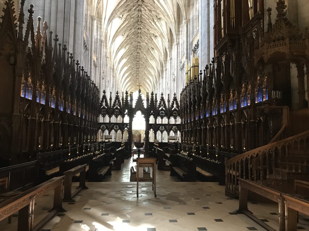 The choir stalls at Winchester Cathedral--just beyond the lectern is a grave on the floor, possibly that of William Rufus, king of England after William the Conqueror.